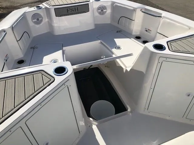Slide: The Image of 2024 Yamaha Boats 220 FSH Sport interior, featuring spacious seating and storage compartments. - 7