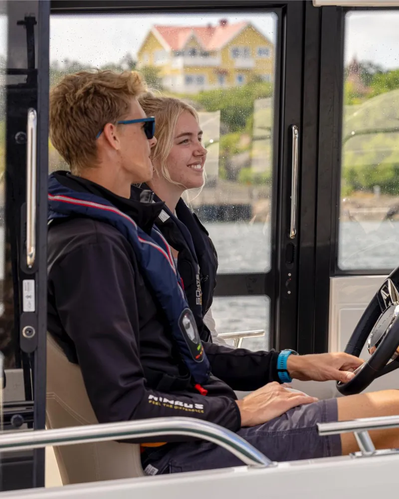 Slide: The Image of Two people enjoying a ride on a 2024 Nimbus C8 boat. - 27