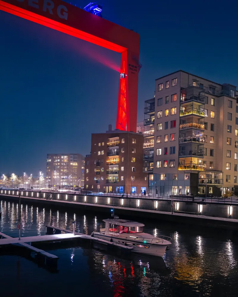 Slide: The Image of Nimbus C8 2024 model boat docked at night in a modern city harbor. - 28