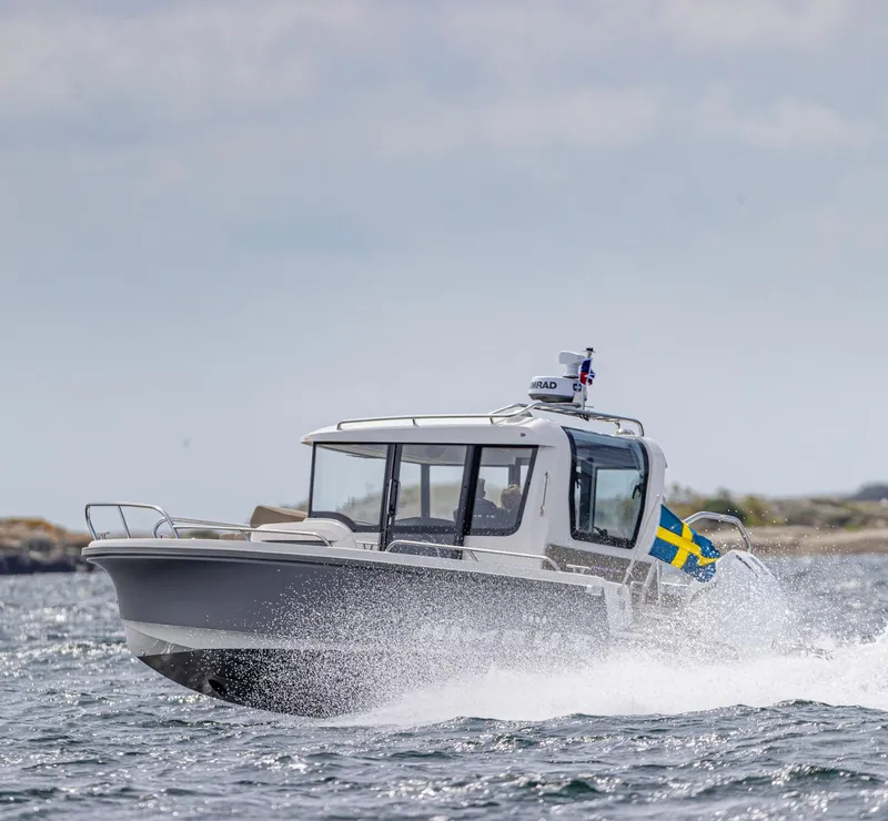 Slide: The Image of 2024 Nimbus C8 boat cruising on water with Swedish flag. - 4