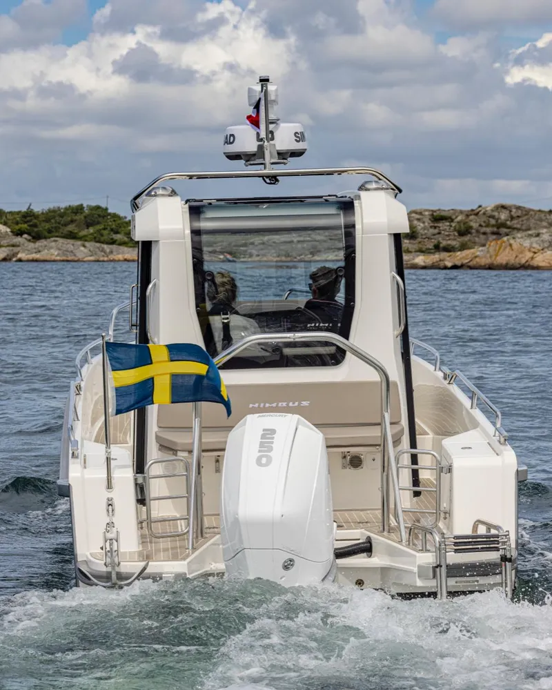 Slide: The Image of 2024 Nimbus C8 boat cruising on water with Swedish flag. - 8