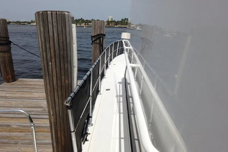 Slide: The Image of 1999 Viking Cockpit Motoryacht docked, showing side deck and railing. - 10
