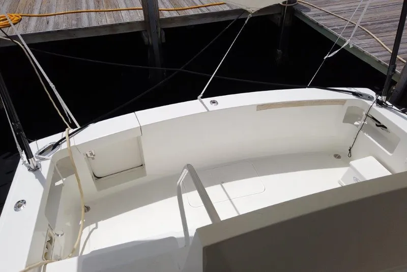 Slide: The Image of 1999 Viking Cockpit Motoryacht with spacious white deck, docked at marina. - 15