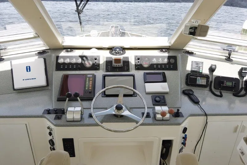 Slide: The Image of Cockpit of 1999 Viking Motoryacht with navigation equipment and steering wheel. - 25