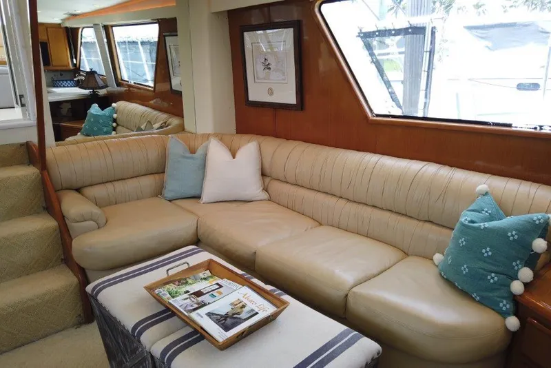 Slide: The Image of Luxurious interior of a 1999 Viking Cockpit Motoryacht with plush seating and decorative pillows. - 29