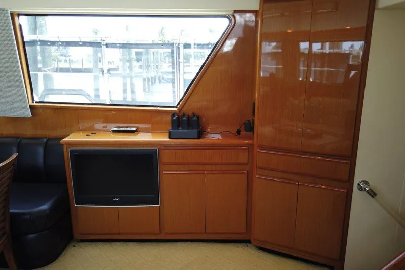 Slide: The Image of 1999 Viking Cockpit Motoryacht interior with wood cabinetry and built-in TV. - 30