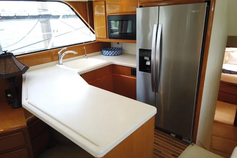Slide: The Image of 1999 Viking Cockpit Motoryacht kitchen with modern appliances and sleek countertops. - 31