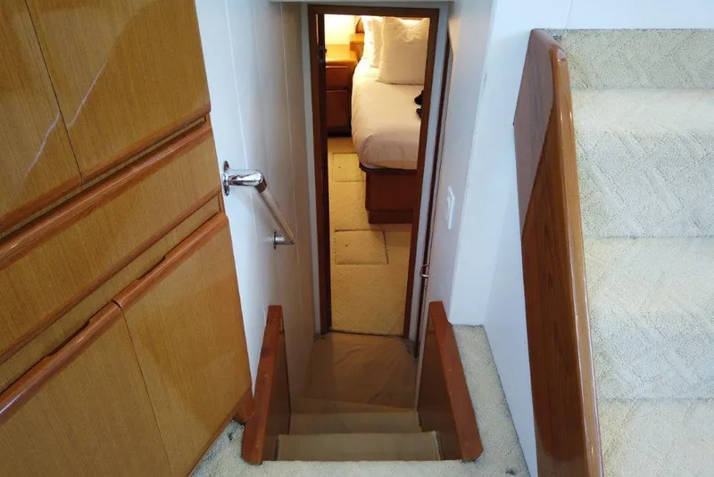 Slide: The Image of Stairway leading to a cozy bedroom in a 1999 Viking Cockpit Motoryacht. - 33