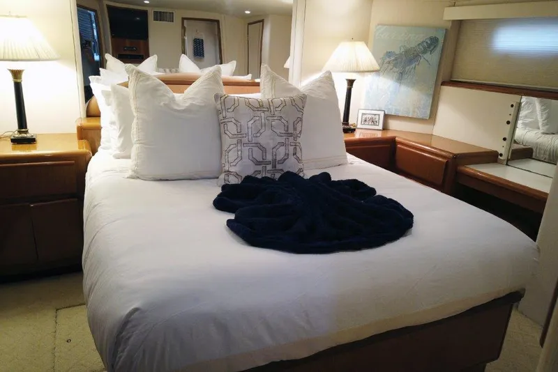 Slide: The Image of Luxurious bedroom interior of 1999 Viking Cockpit Motoryacht with elegant bedding and soft lighting. - 34