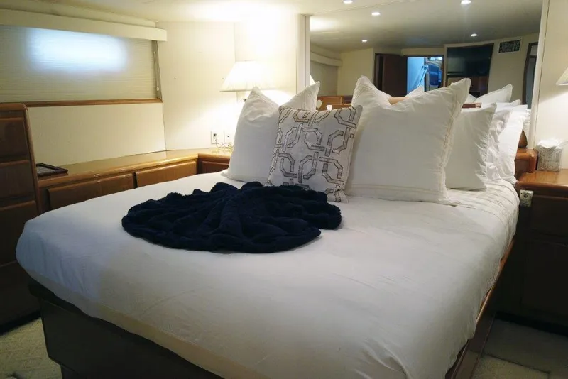 Slide: The Image of Luxurious bedroom in 1999 Viking Cockpit Motoryacht with plush bedding and elegant decor. - 35