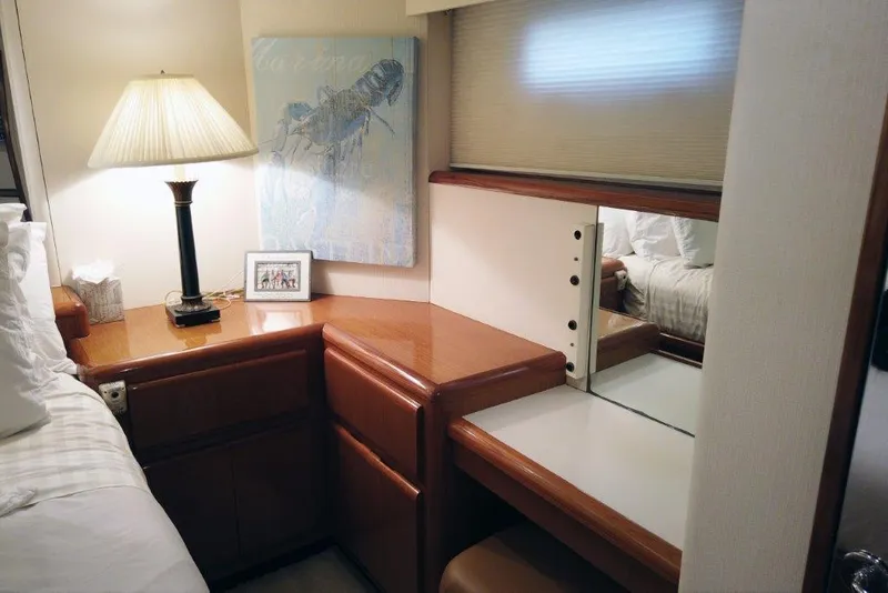 Slide: The Image of 1999 Viking Cockpit Motoryacht interior with wooden desk, lamp, and mirror. - 37