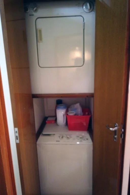 Slide: The Image of Laundry area in 1999 Viking Cockpit Motoryacht with stacked washer and dryer. - 49