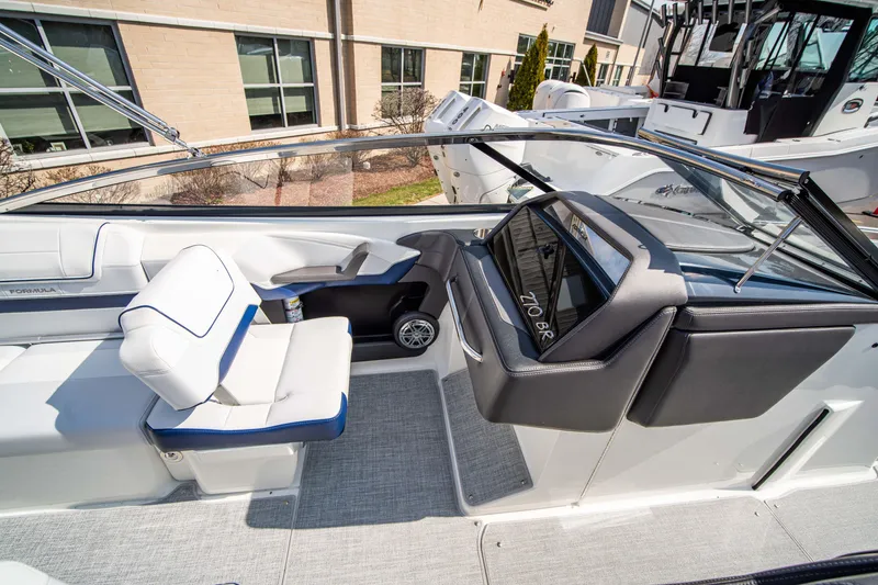 Slide: The Image of 2024 Formula 270 Bowrider interior with white and blue seating, modern dashboard. - 13