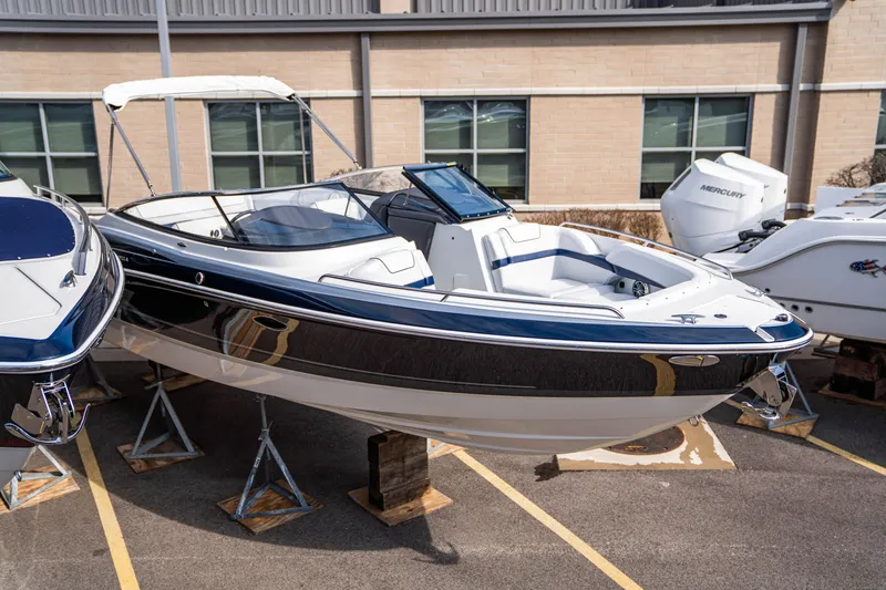 Slide: The Image of 2024 Formula 270 Bowrider boat displayed on stands in a parking lot. - 14