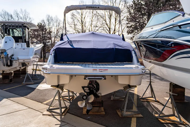 Slide: The Image of 2024 Formula 270 Bowrider boat on stands, covered and ready for storage. - 16