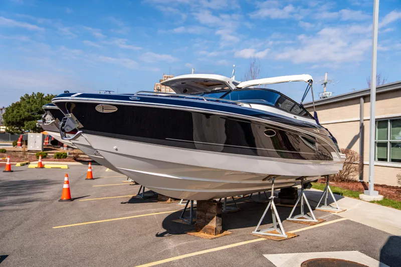 Slide: The Image of 2024 Formula 270 Bowrider boat on stands in a parking lot. - 17