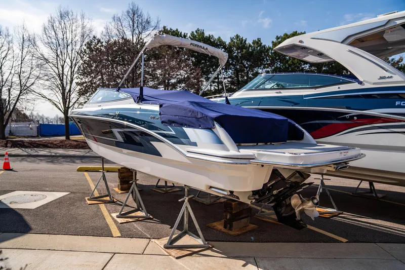 Slide: The Image of 2024 Formula 270 Bowrider boat on stands, covered and parked outdoors. - 20