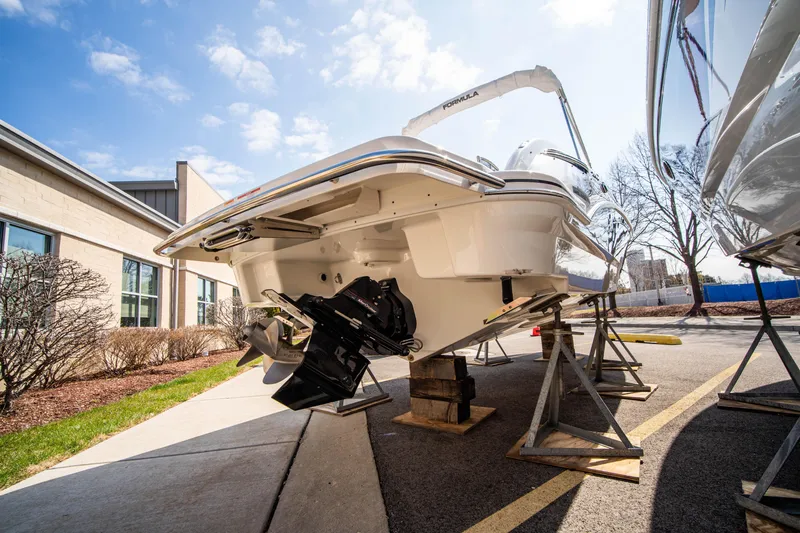 Slide: The Image of 2024 Formula 270 Bowrider boat on stands, rear view, outdoor display. - 21