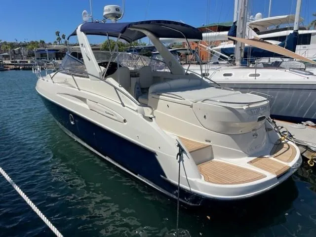 Slide: The Image of 2005 Cranchi 33 Express yacht docked in a marina, featuring sleek design and spacious deck. - 0