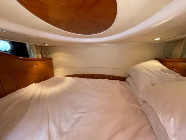 Slide: The Image of Luxurious cabin interior of 2005 Cranchi 33 Express yacht with cozy bedding. - 10