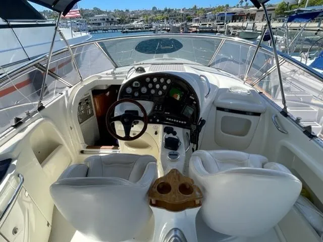 Slide: The Image of 2005 Cranchi 33 Express yacht cockpit with steering wheel and control panel, docked at marina. - 12