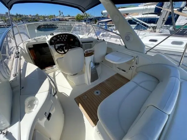 Slide: The Image of 2005 Cranchi 33 Express yacht interior with helm, seating, and wooden flooring. - 15