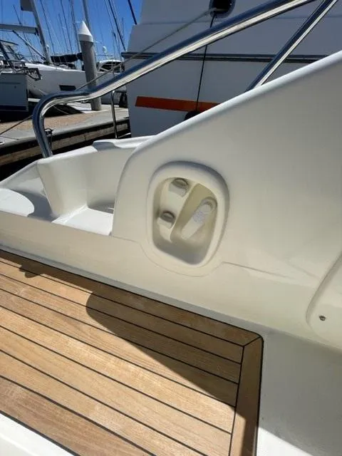 Slide: The Image of 2005 Cranchi 33 Express boat deck with wooden flooring and sleek design. - 17