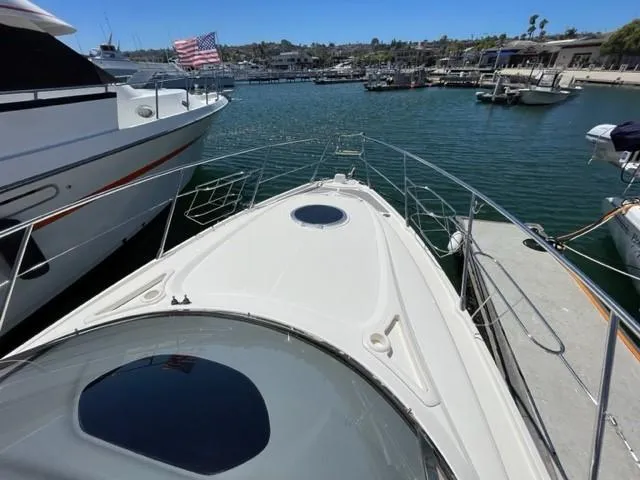 Slide: The Image of 2005 Cranchi 33 Express yacht docked in a marina, American flag visible. - 19