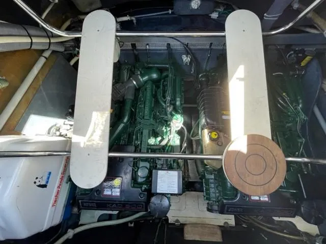 Slide: The Image of Engine compartment of a 2005 Cranchi 33 Express boat, showcasing dual engines and mechanical components. - 25