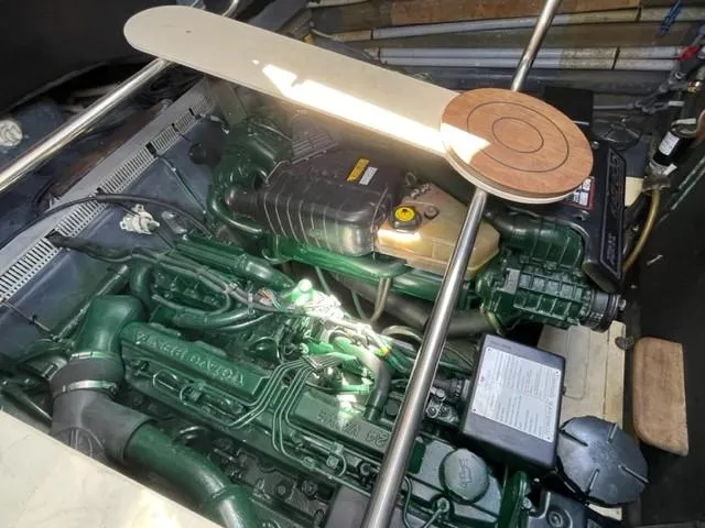 Slide: The Image of Engine compartment of a 2005 Cranchi 33 Express boat, showcasing detailed machinery. - 27