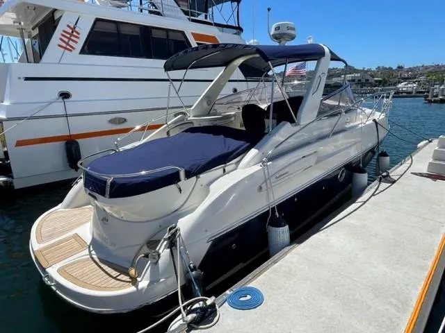Slide: The Image of 2005 Cranchi 33 Express yacht docked at marina under clear blue sky. - 28