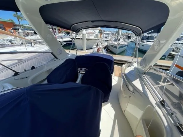 Slide: The Image of 2005 Cranchi 33 Express yacht interior with blue covers, docked at a marina. - 6