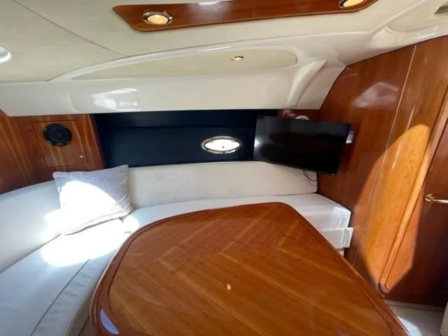 Slide: The Image of Luxurious interior of 2005 Cranchi 33 Express yacht with wood finish and seating area. - 7