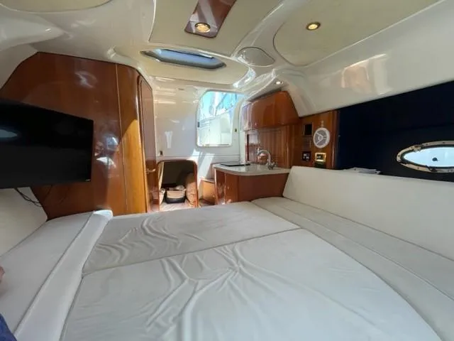 Slide: The Image of Interior of 2005 Cranchi 33 Express yacht with bed, kitchenette, and TV. - 8