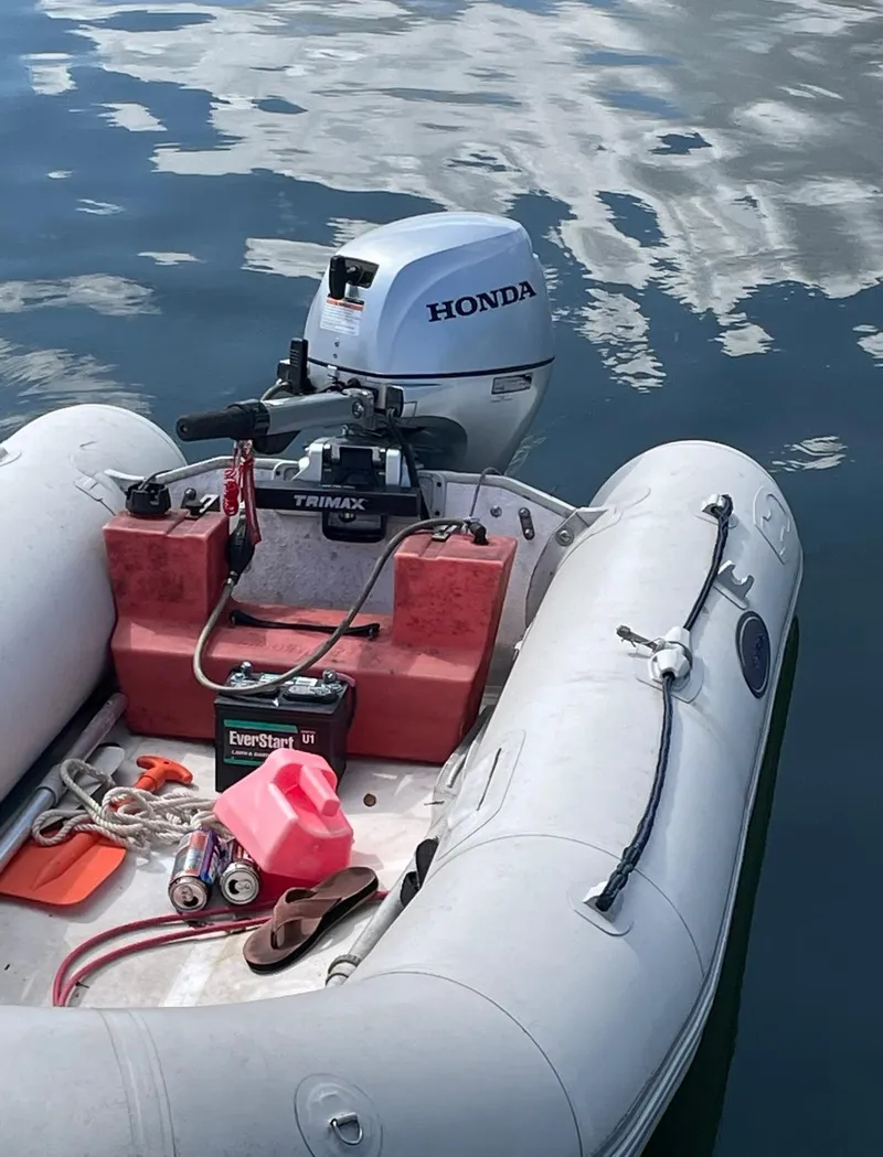 Slide: The Image of Inflatable boat with Honda outboard motor and boating equipment on water. - 11