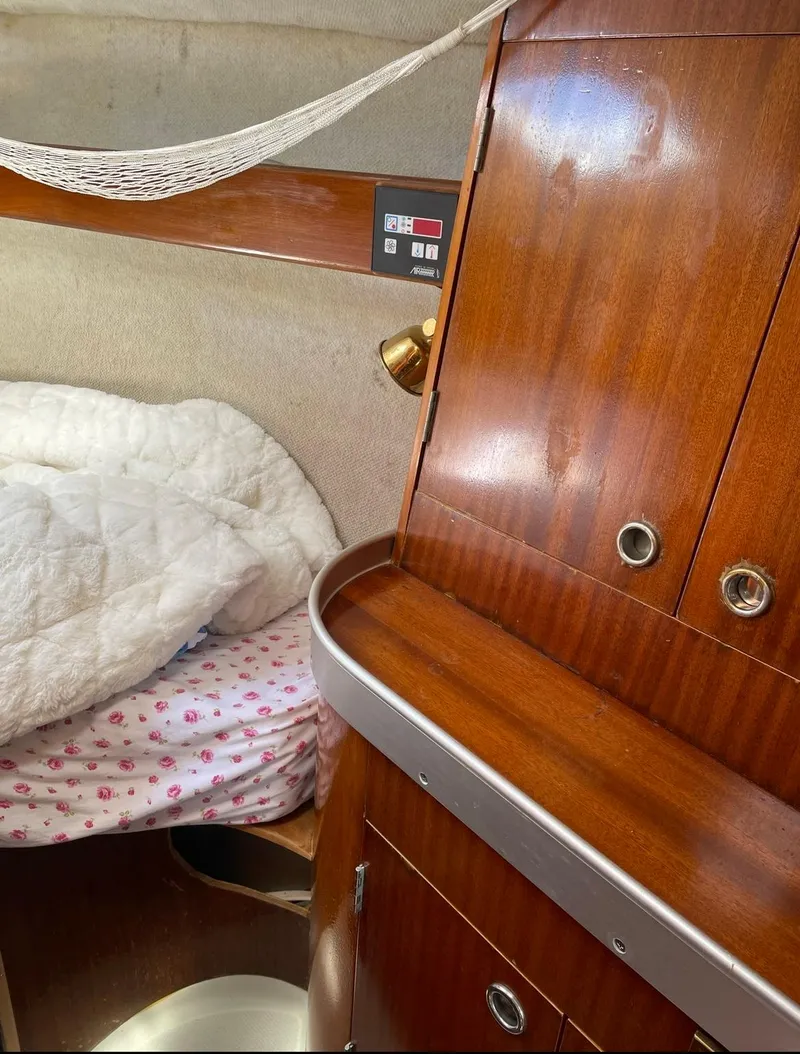 Slide: The Image of Interior cabin of a 1990 Beneteau M38 sailboat with wooden cabinetry. - 12