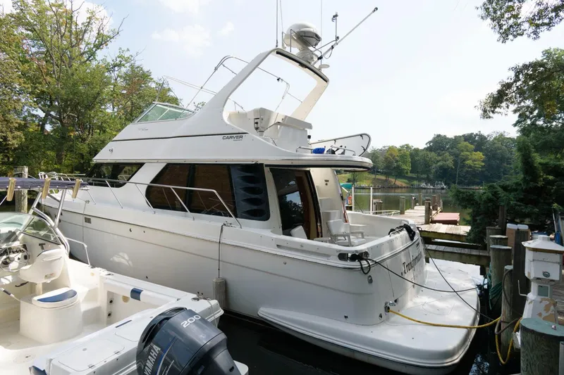 The Image of 2003 Carver 450 Voyager Pilothouse yacht docked at a marina. - 0