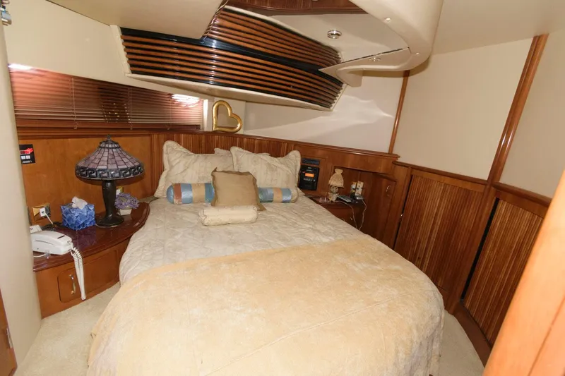 Slide: The Image of Luxurious bedroom in 2003 Carver 450 Voyager Pilothouse yacht with cozy bedding. - 10