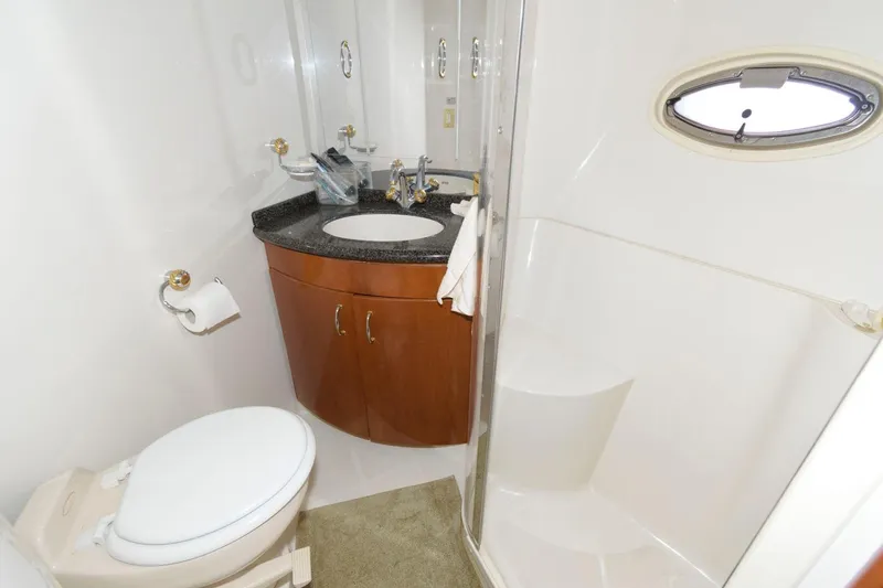 Slide: The Image of 2003 Carver 450 Voyager Pilothouse bathroom with sink, toilet, and shower. - 11