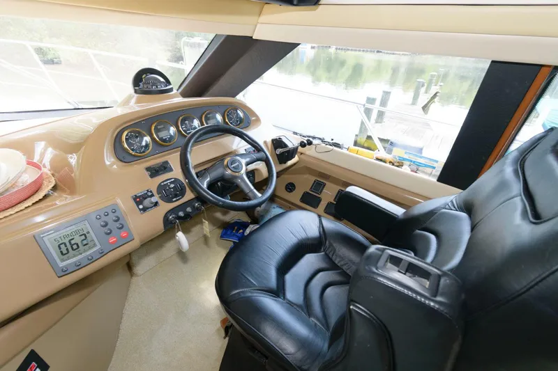 Slide: The Image of 2003 Carver 450 Voyager Pilothouse helm with leather captain's chair and navigation instruments. - 3