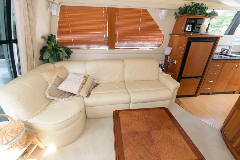 Slide: The Image of Interior of 2003 Carver 450 Voyager Pilothouse with beige leather sofa and wooden accents. - 6