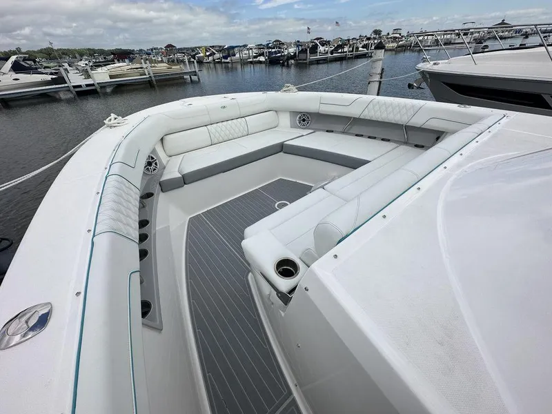 Slide: The Image of 2024 Regal 38SAV boat with spacious seating at a marina. - 14