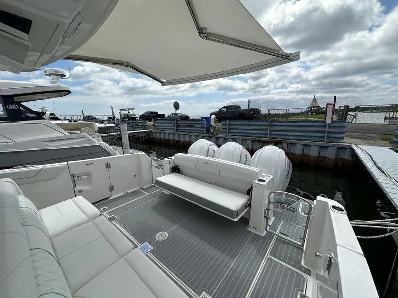 Slide: The Image of 2024 Regal 38SAV luxury boat docked, featuring spacious seating and modern amenities. - 4