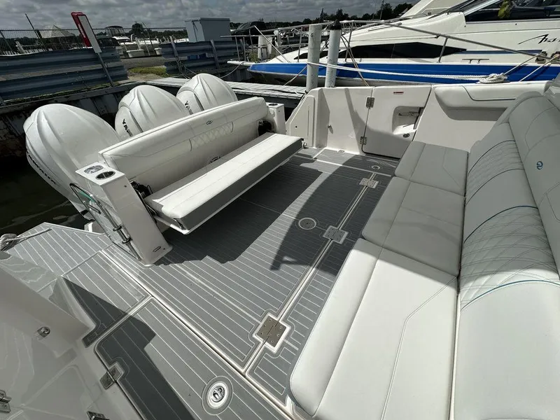 Slide: The Image of 2024 Regal 38SAV boat with spacious seating and triple outboard engines. - 6