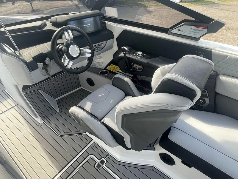 Slide: The Image of 2022 Nautique Super Air Nautique G23 boat interior with steering wheel and dashboard. - 10