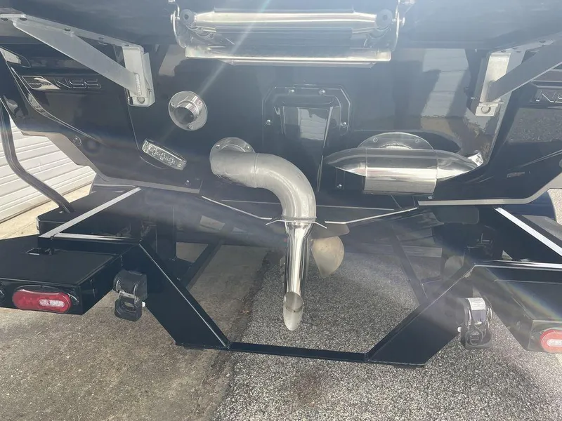 Slide: The Image of 2022 Nautique Super Air Nautique G23 boat rear view showing exhaust and trailer. - 3