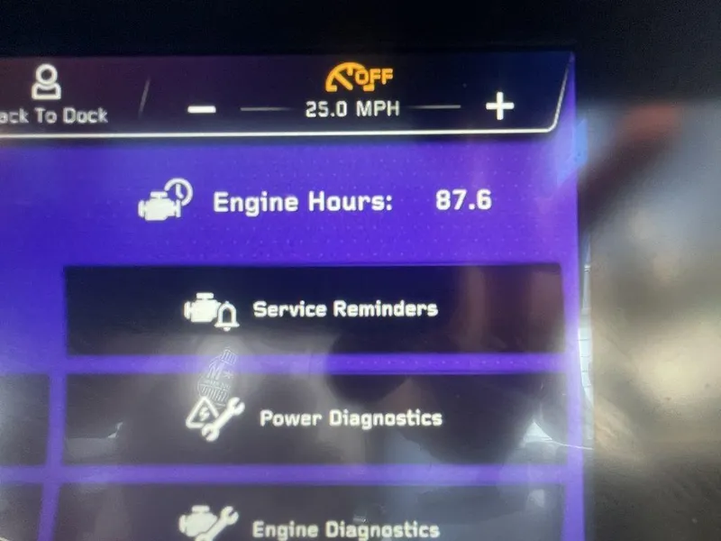 Slide: The Image of 2022 Nautique Super Air Nautique G23 dashboard showing 87.6 engine hours and service reminders. - 8