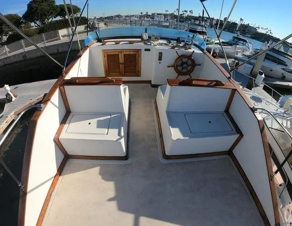 Slide: The Image of 1977 CHB 34 Double Cabin boat deck with seating and steering wheel. - 11