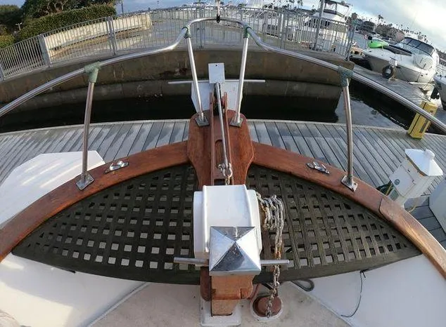 Slide: The Image of 1977 CHB 34 Double Cabin boat bow with anchor and dock background. - 14