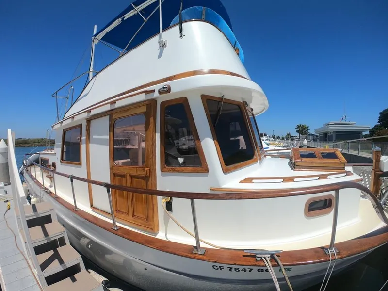 Slide: The Image of 1977 CHB 34 Double Cabin boat docked at marina under clear blue sky. - 16